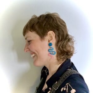 Side profile of me, with a new mullet cut and my fancy sparkly snake earrings. Feeling fabulous and Queer and utterly me!